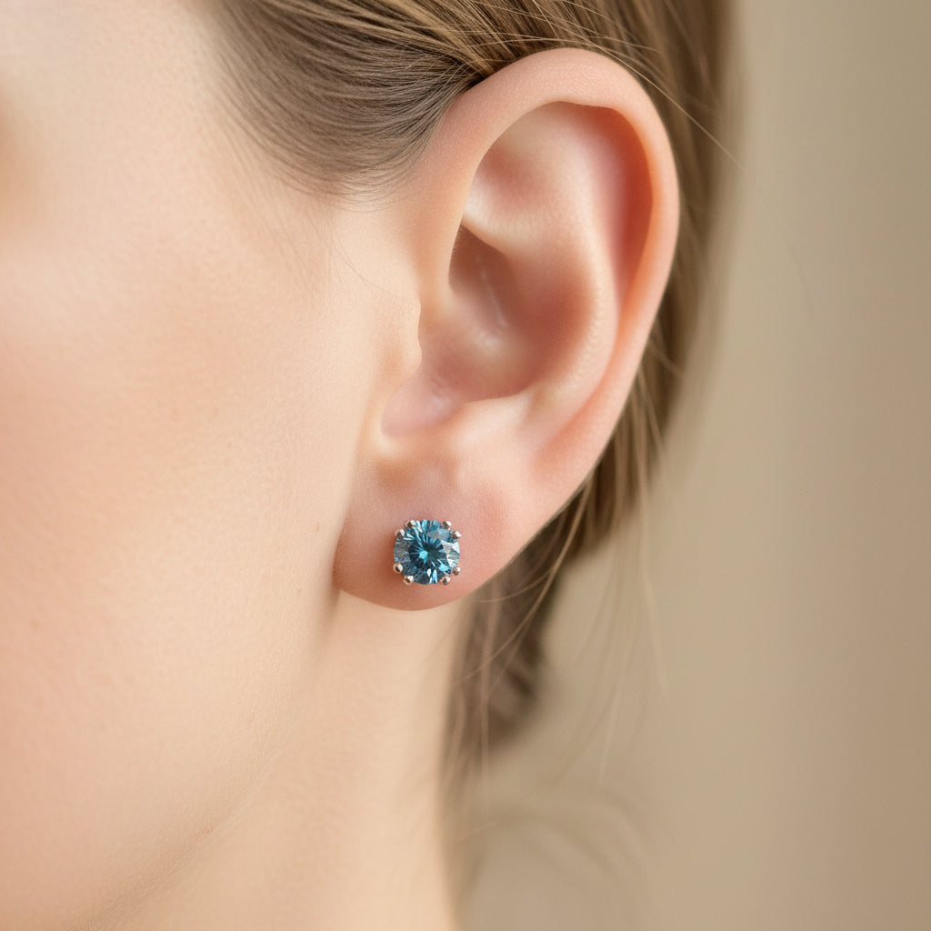 One pair of blue diamond stud earrings in 14k white gold