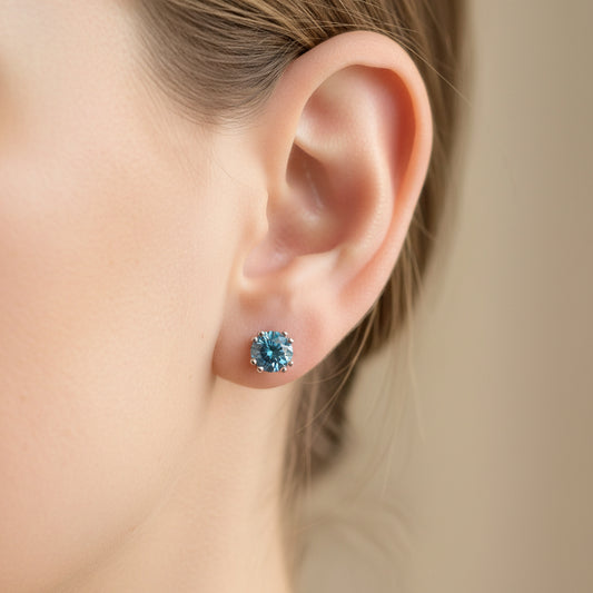One pair of blue diamond stud earrings in 14k white gold